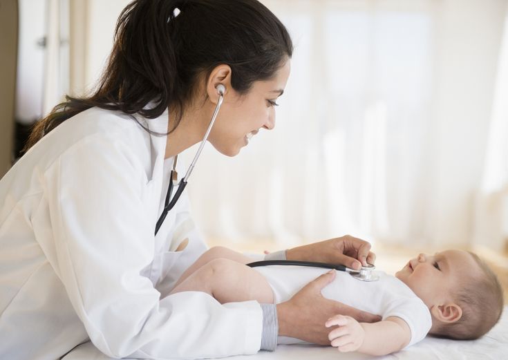 Pediatric orthopedic specialist screening a child for bone and joint deformities